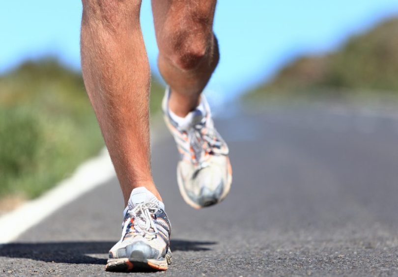 Runner training outdoors with focus on lower leg strength and injury prevention at Malvern Physio.